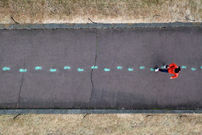 A top down photo of a person walking along an empty road